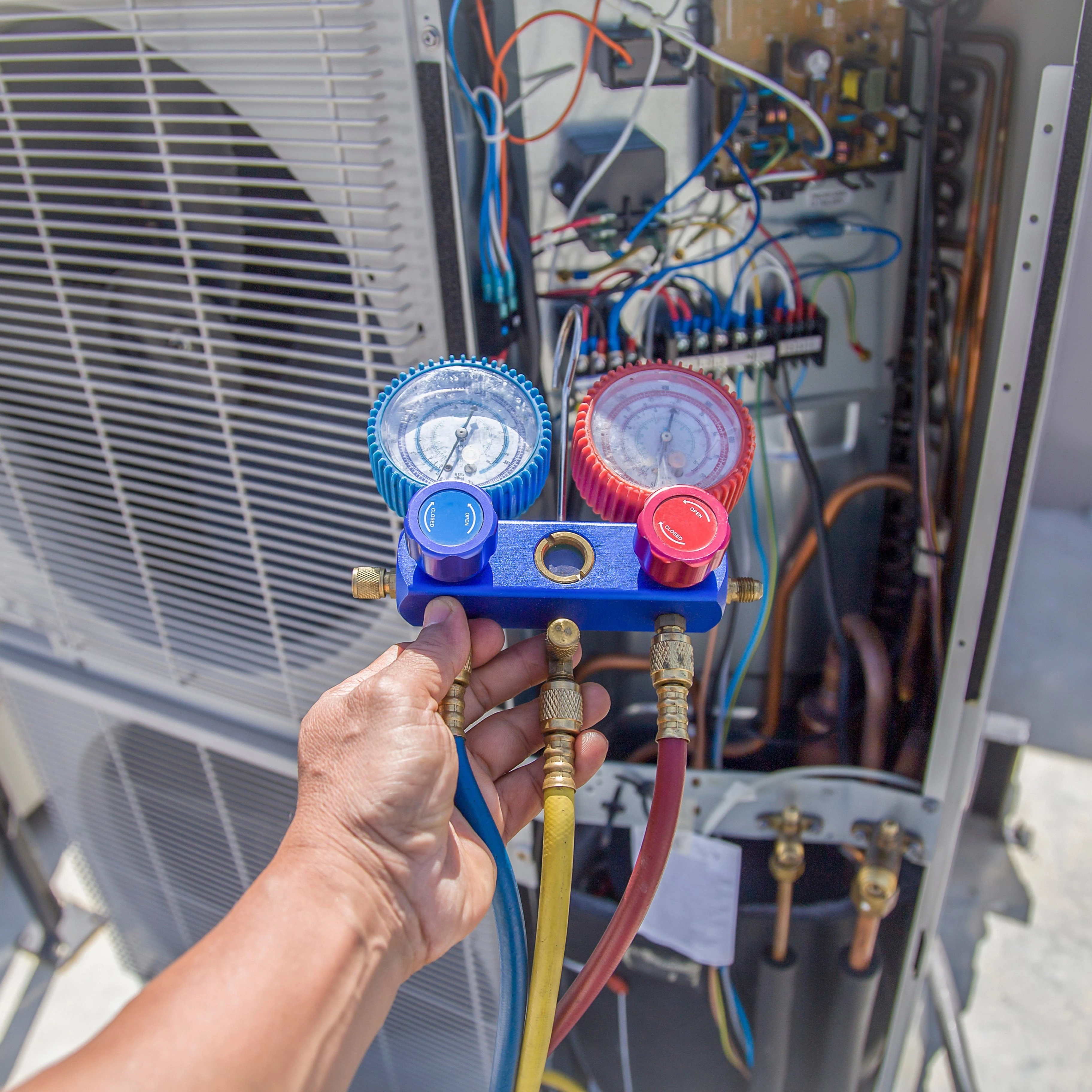 A tech from Automated Tech Solutions doing HVAC services in OKC